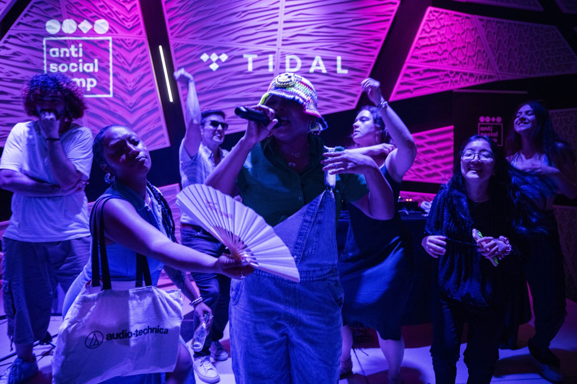 an artist performing with many people dancing
