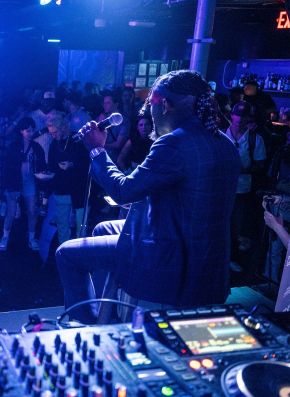 an artist performing in front of a dj booth