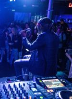artist performing in front of a dj booth